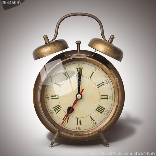 Image of Brown old style alarm clock with shadow