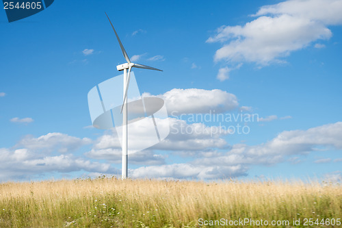 Image of Wind generator turbine on summer landscape