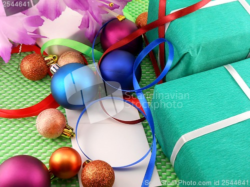 Image of A gift box with a white ribbon and new year balls