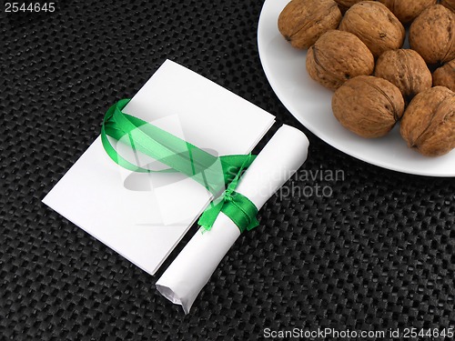 Image of Walnuts on a white plate with invitation card