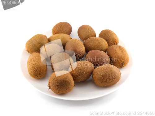 Image of kiwi set on white plate isolated on white