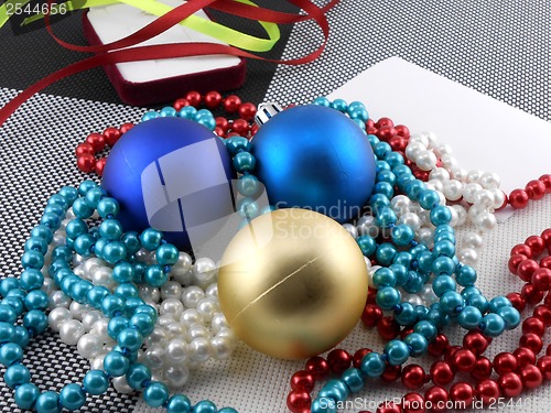 Image of christmas ball and pearls on a plate, new year holiday card