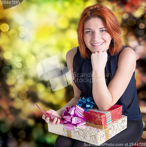 Image of Emotional smiling woman with boxes gifts