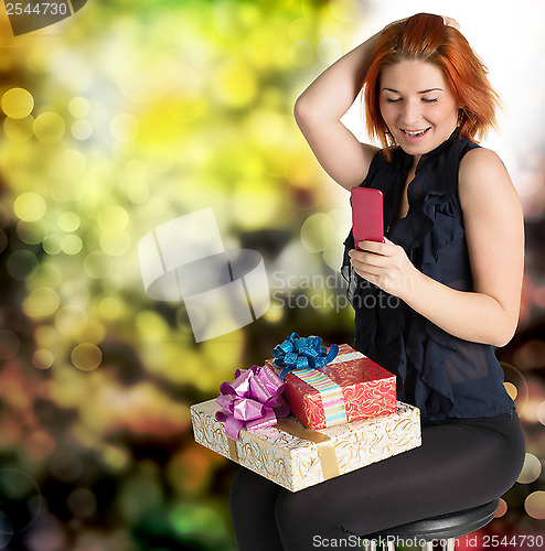 Image of Emotional smiling woman with boxes gifts