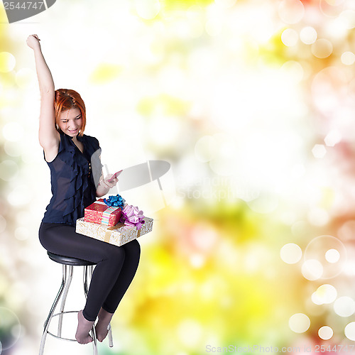 Image of Emotional smiling woman with boxes gifts 