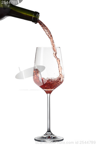 Image of Red wine pouring into glass with splash isolated on white