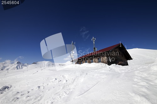 Image of Wooden hotel at snowy mountains