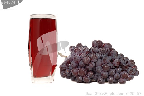 Image of A glass of grape juice with a cluster of grapes