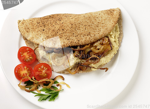 Image of Hummus and fried onion pita sandwich