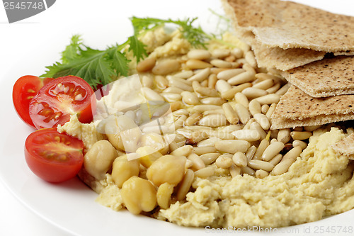 Image of Lebanese hummus and pine nuts withoil