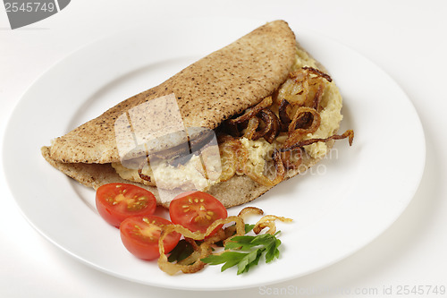 Image of Pitta bread with hommos and onions