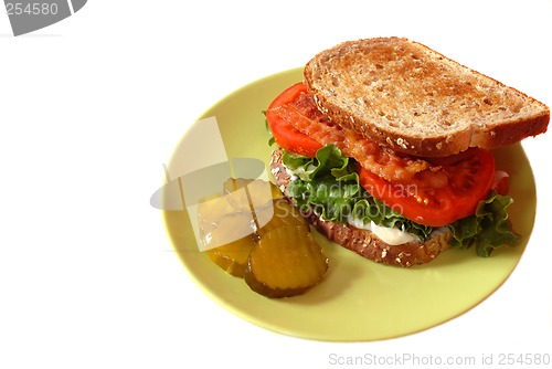 Image of A bacon, lettuce and tomato sandwich with pickles isolated on wh
