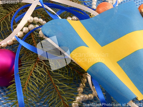 Image of Sweden flag with christmas decoration, new year card