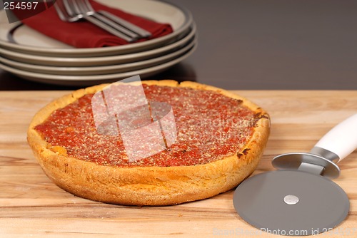 Image of A Chicago style deep dish pizza on a cutting board