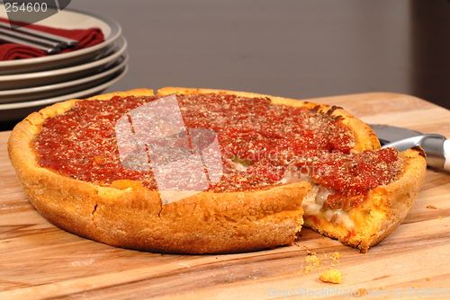 Image of Chicago style deep dish pizza with a piece cut out