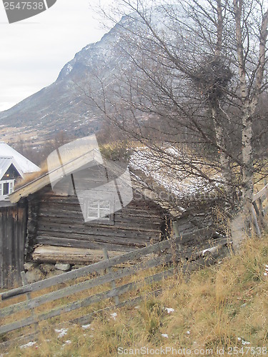 Image of Old wooden house by the mountains