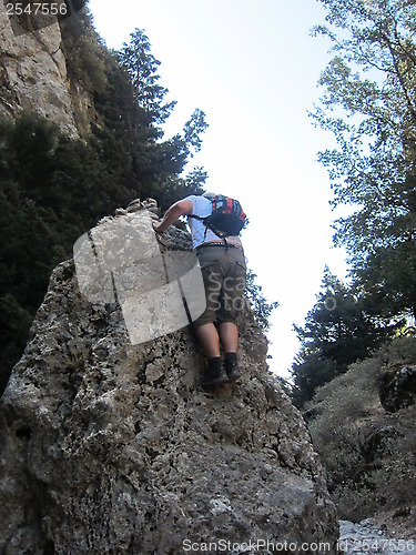 Image of Man climbing a rock