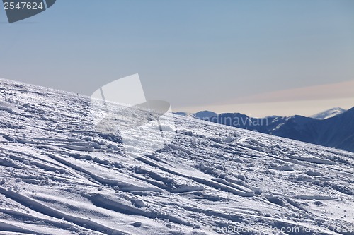 Image of Ski slope with trace from ski and snowboards in newly - fallen s