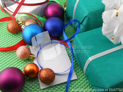 Image of A gift box with a white ribbon and new year balls