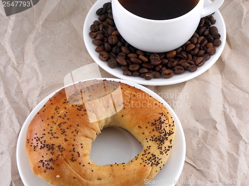 Image of Coffee and coffee beans on white plate with sweet cake