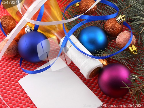 Image of champagne bottle with christmas ball and blue ribbon, invitation card