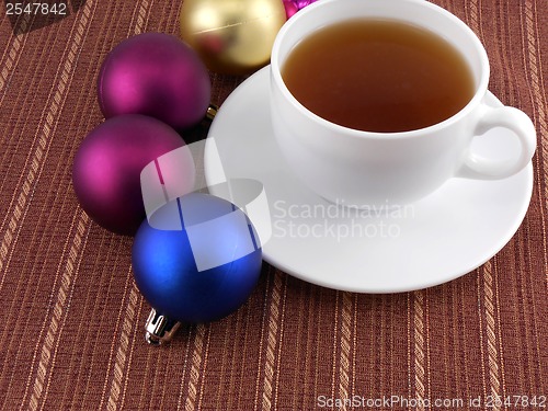 Image of tea white cup and christmas baubles, holiday concept