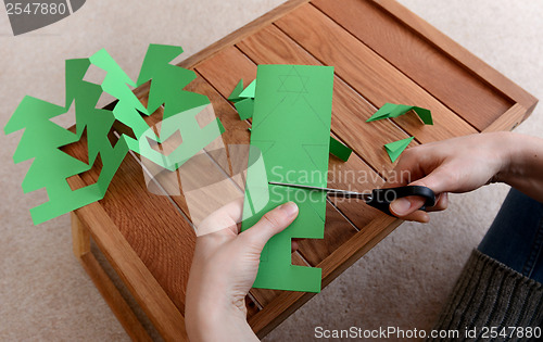 Image of Cutting a paper Christmas tree chain