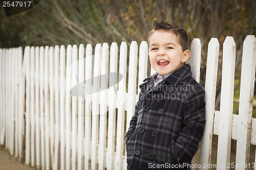 Image of Young Mixed Race Boy Waiting For School Bus Along Fence