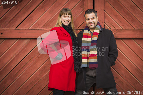 Image of Mixed Race Couple Portrait in Winter Clothing Against Barn Door