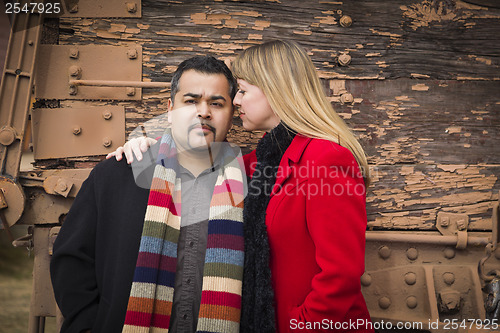 Image of Mixed Race Couple Portrait in Winter Clothing Against Rustic Tra