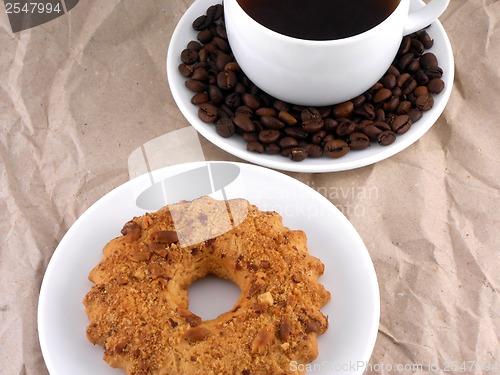 Image of Coffee and coffee beans on white plate with sweet cake