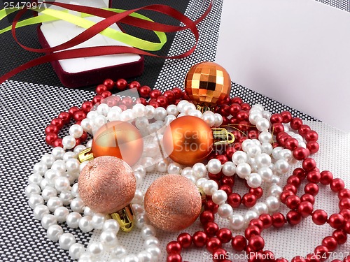 Image of christmas ball and pearls on a plate, new year holiday card