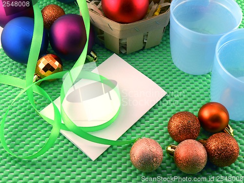 Image of Christmas balls on green background, new year decoration