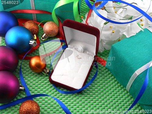 Image of A gift box with a white ribbon and new year balls