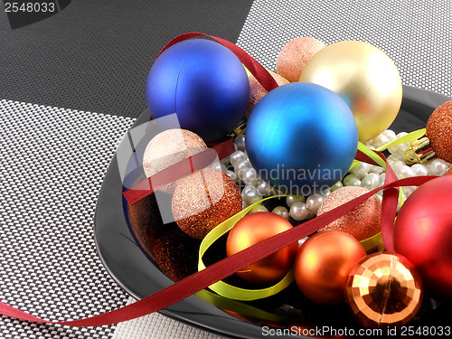 Image of decorative christmas ball and pearls on a plate, new year holiday