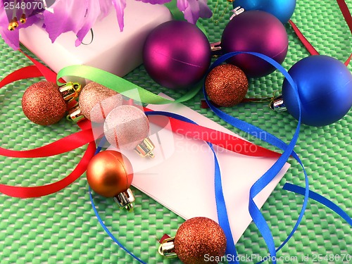 Image of A white gift with a green ribbon and new year balls