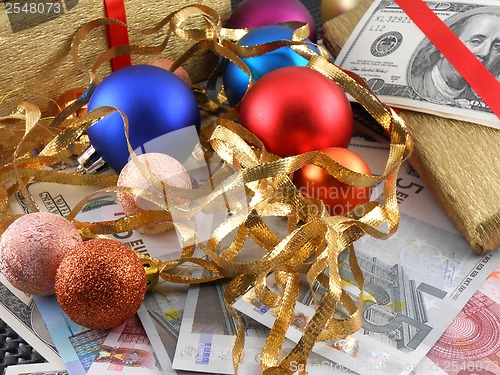 Image of Christmas gift box with christmas balls and money