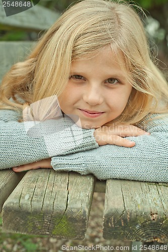 Image of pretty girl on a bench 