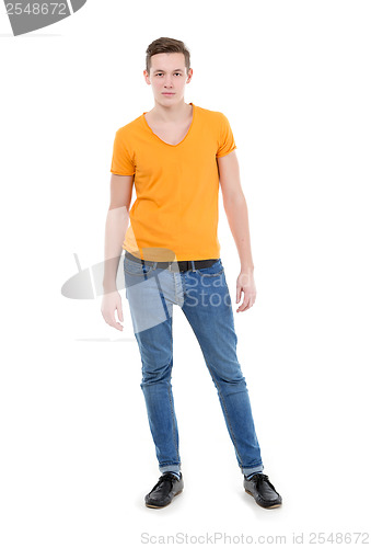 Image of Young man wearing a yellow T-shirt and slim jeans