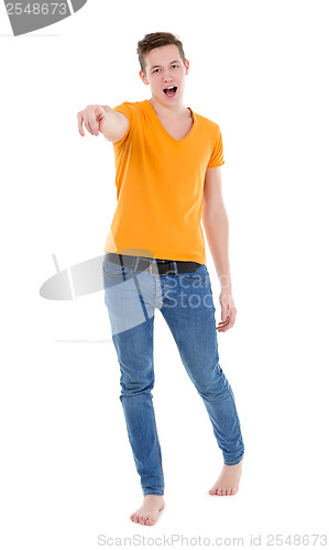 Image of Young man wearing a yellow T-shirt and slim jeans