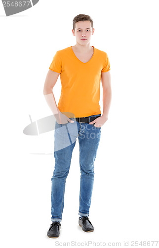 Image of Young man wearing a yellow T-shirt and slim jeans