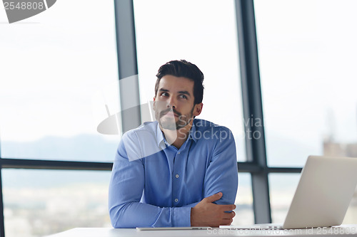 Image of happy young business man at office