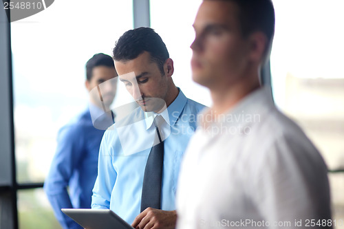 Image of business man using tablet compuer at office