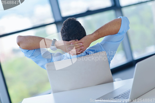 Image of happy young business man at office