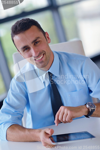 Image of business man using tablet compuer at office