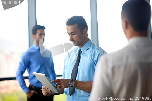 Image of business man using tablet compuer at office