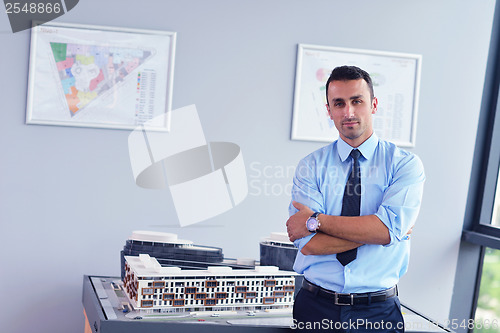 Image of happy young business man at office