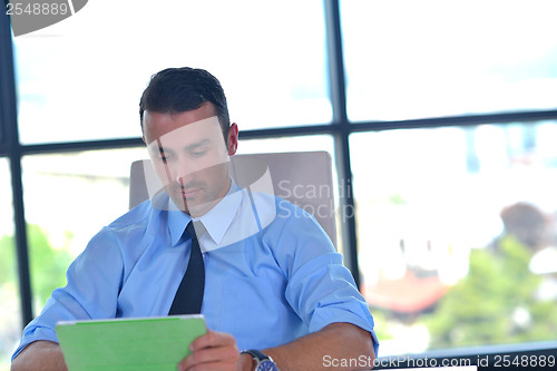 Image of business man using tablet compuer at office