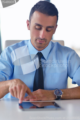 Image of business man using tablet compuer at office