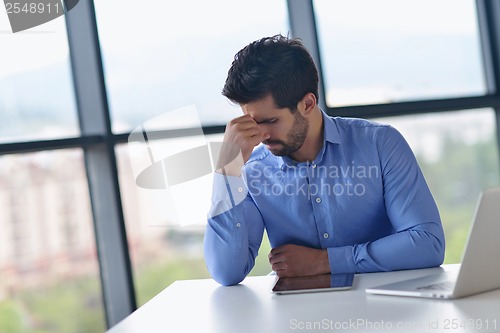 Image of happy young business man at office